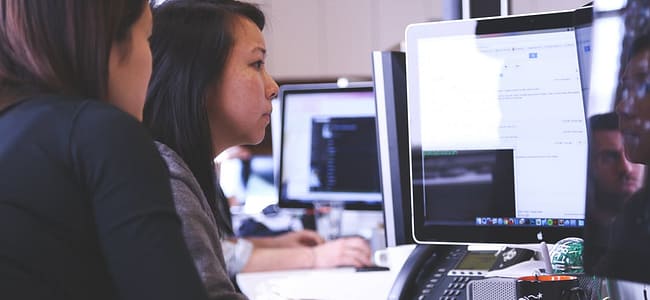 women in front of computer